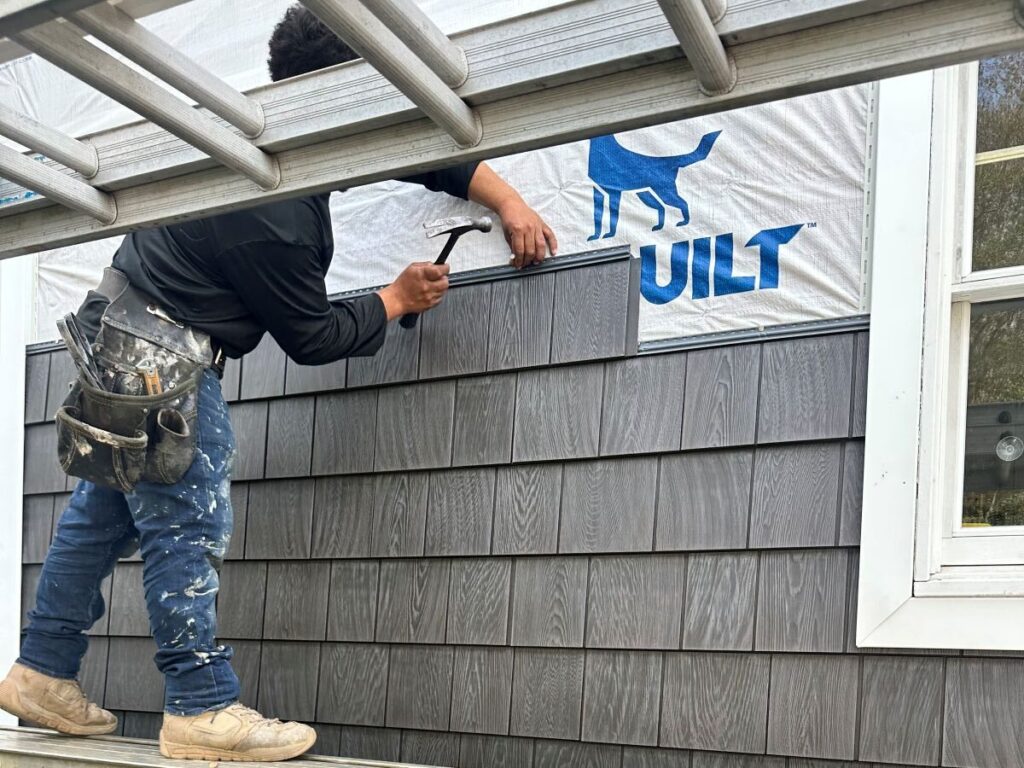 types of siding Grand Exteriors worker installing new siding