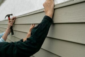 siding repair hands holding wood