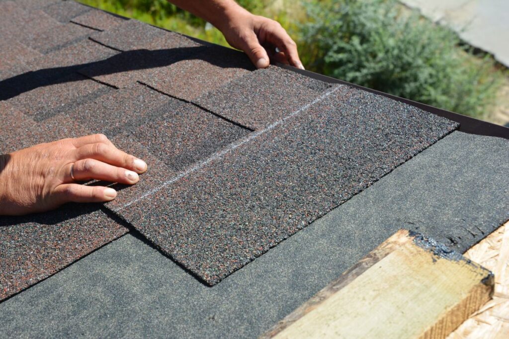 asphalt shingle roof installation worker replacing new piece