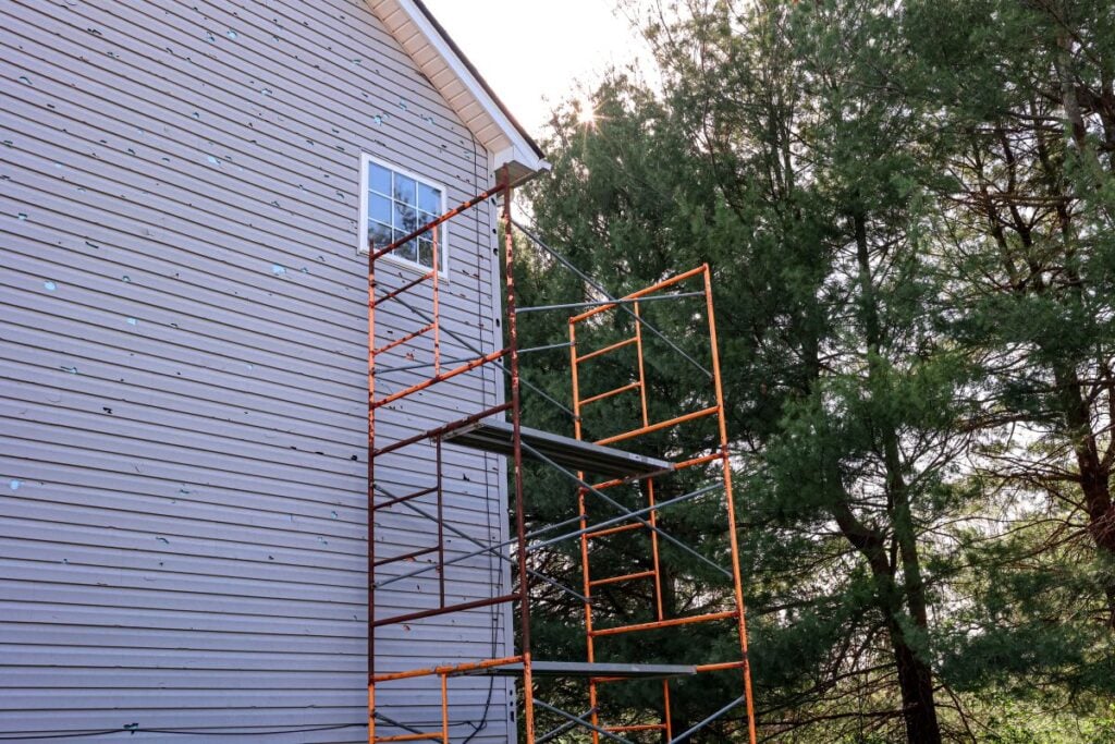 Siding repair bad state siding with cracks and structure for workers