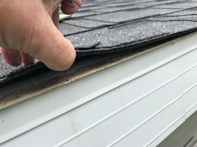 roof inspection checklist hand lifting shingles