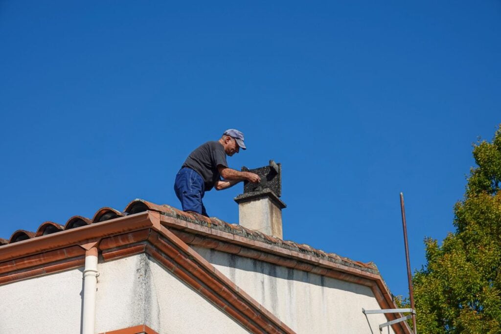roof inspection checklist worker inspecting inside chimney