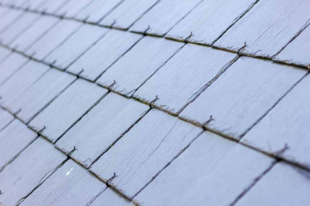 A close up portrait of a blue, black slate tile roof